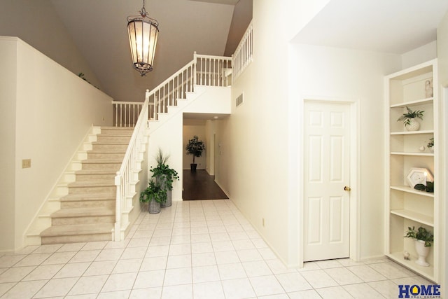 6427 Lone Tree Dr, Lincoln, NE 68512 - foyer featuring stairway, light tile patterned floors, and a chandelier