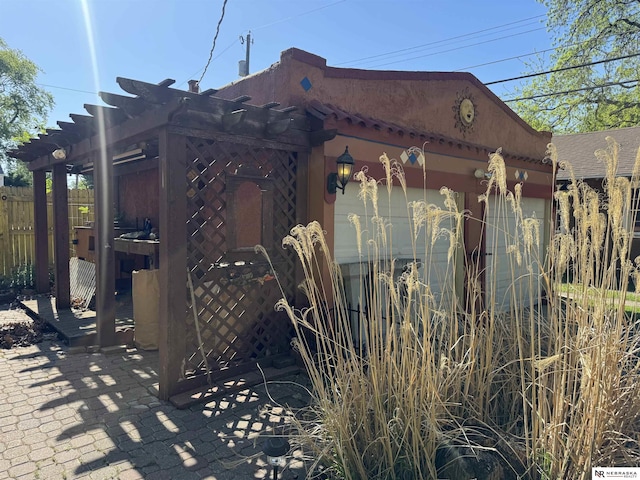 1244 N Elm St, Wahoo, NE 68066 - view of side of home with fence and a pergola