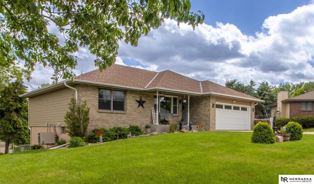 719 Cory Dr, Seward, NE 68434 - single story home featuring brick siding, a front yard, an attached garage, and central AC unit