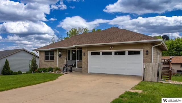 719 Cory Dr, Seward, NE 68434 - ranch-style house with driveway, a garage, brick siding, and roof with shingles