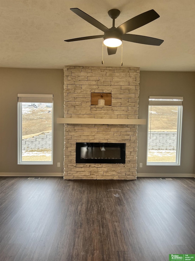 17521 Clay St, Elkhorn, NE 68007 - unfurnished living room with wood finished floors, a stone fireplace, baseboards, and ceiling fan