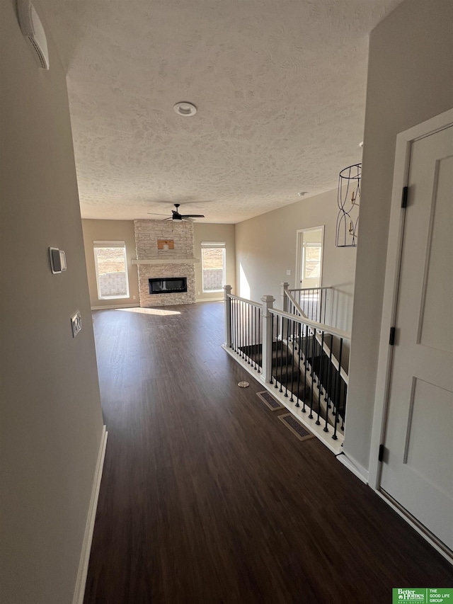 17521 Clay St, Elkhorn, NE 68007 - corridor featuring a textured ceiling, wood finished floors, an upstairs landing, and baseboards