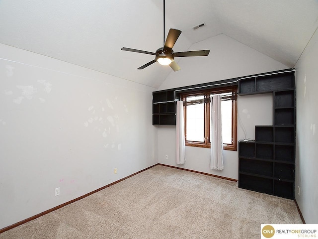 unfurnished bedroom with lofted ceiling, light colored carpet, baseboards, and a ceiling fan