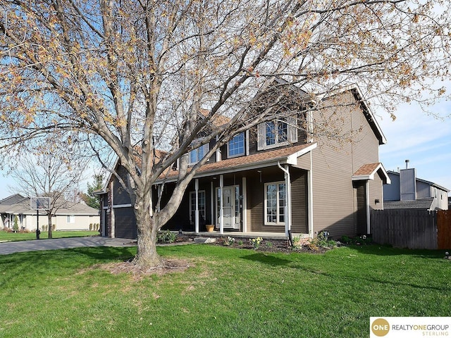 view of front of property with covered porch, asphalt driveway, and a garage