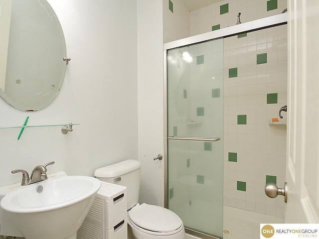 full bathroom with a sink, a shower stall, and toilet