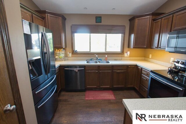 14311 Oldfield St, Waverly, NE 68462 - kitchen with dishwashing machine, stainless steel refrigerator with ice dispenser, black range with electric cooktop, dark wood-style floors, and light countertops