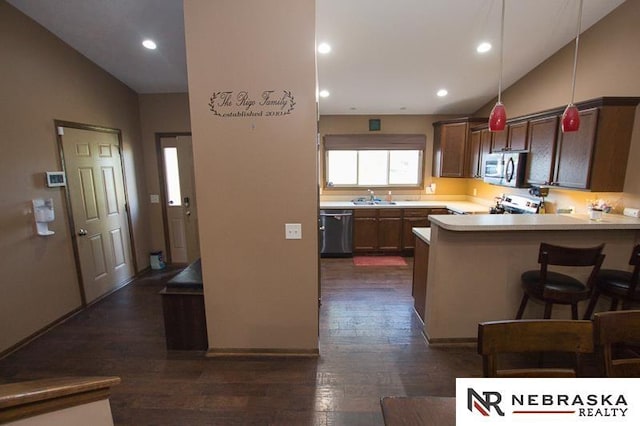 14311 Oldfield St, Waverly, NE 68462 - kitchen featuring stainless steel appliances, a sink, lofted ceiling, light countertops, and dark wood-type flooring