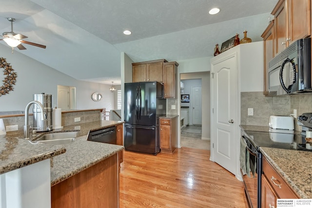 16315 Craig Ave, Bennington, NE 68007 - kitchen with black appliances, a sink, brown cabinetry, light wood finished floors, and decorative backsplash