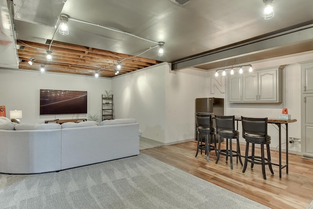 16315 Craig Ave, Bennington, NE 68007 - living area with light wood-style floors, baseboards, and a dry bar