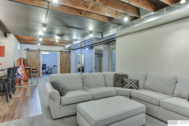 16315 Craig Ave, Bennington, NE 68007 - living area with a barn door, wood finished floors, and carpet