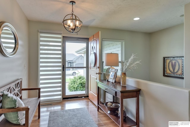 16315 Craig Ave, Bennington, NE 68007 - doorway with a chandelier, wood finished floors, and recessed lighting