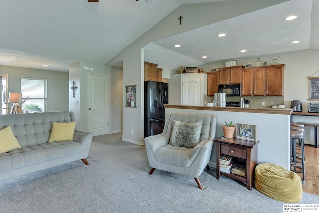 16315 Craig Ave, Bennington, NE 68007 - living area with vaulted ceiling, light carpet, recessed lighting, and baseboards