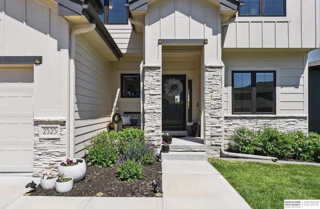 doorway to property featuring stone siding and board and batten siding