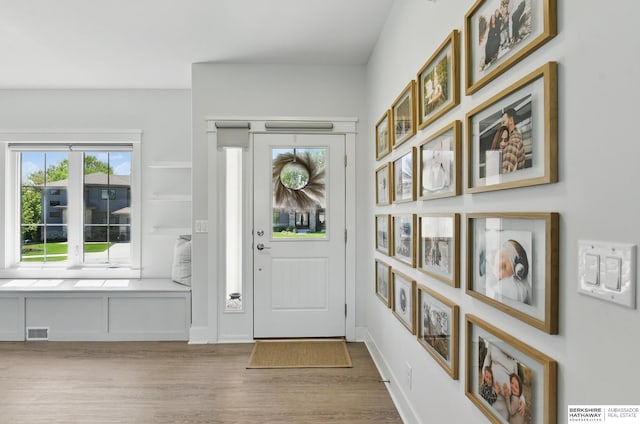 entryway with wood finished floors