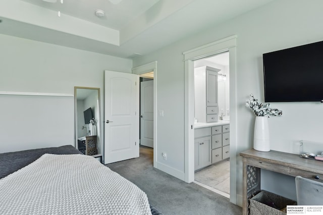 bedroom featuring carpet flooring, ensuite bath, and baseboards