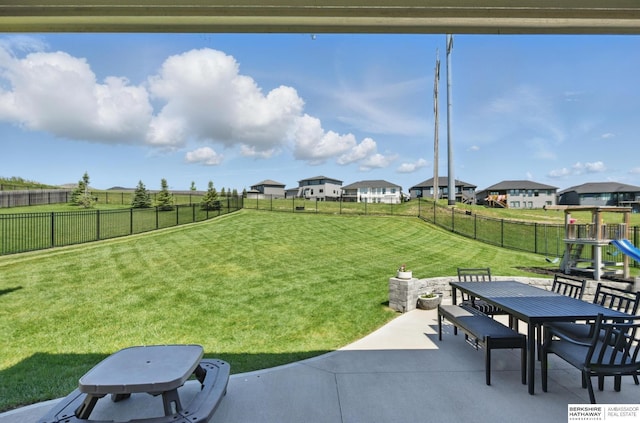 view of yard featuring outdoor dining space, a patio area, and a playground