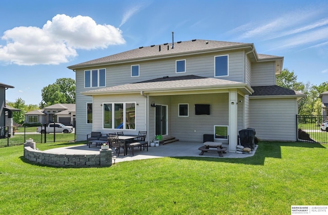 rear view of property with entry steps, a patio, and a shingled roof