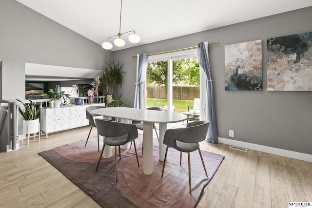 18667 R St, Omaha, NE 68135 - dining area with wood finished floors, baseboards, and high vaulted ceiling