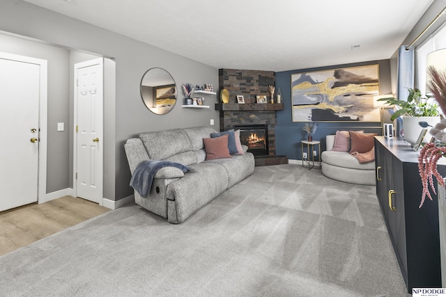18667 R St, Omaha, NE 68135 - carpeted living area featuring a fireplace, baseboards, and wood finished floors