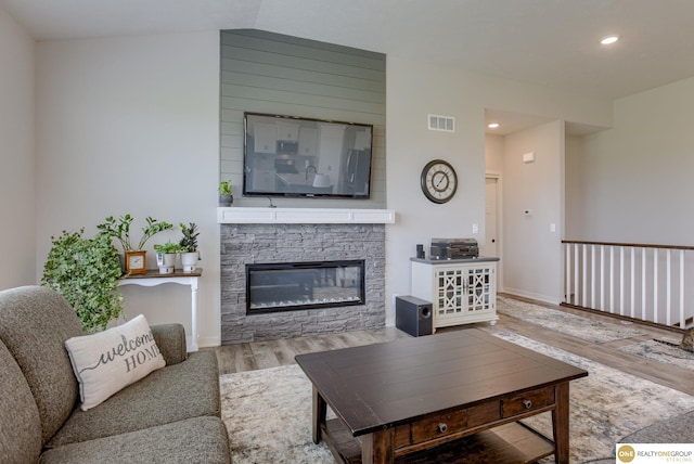 12618 Glenn St, Omaha, NE 68138 - living area with wood finished floors, recessed lighting, a stone fireplace, and baseboards