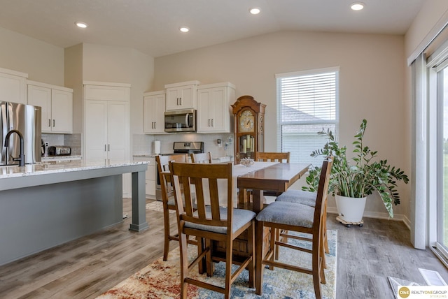 12618 Glenn St, Omaha, NE 68138 - dining room with vaulted ceiling, light wood-style flooring, and recessed lighting