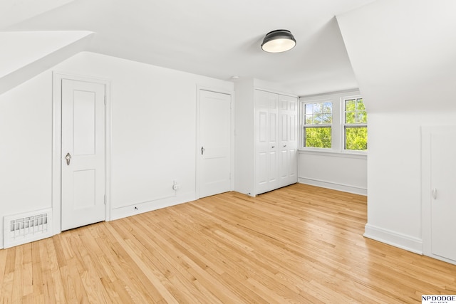 bonus room with light wood finished floors