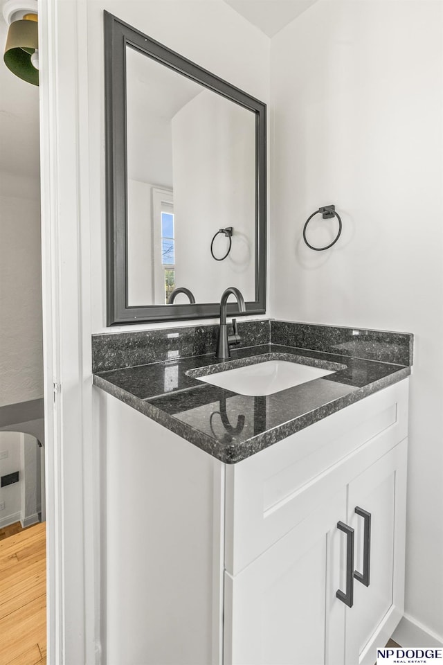 bathroom with wood finished floors and vanity