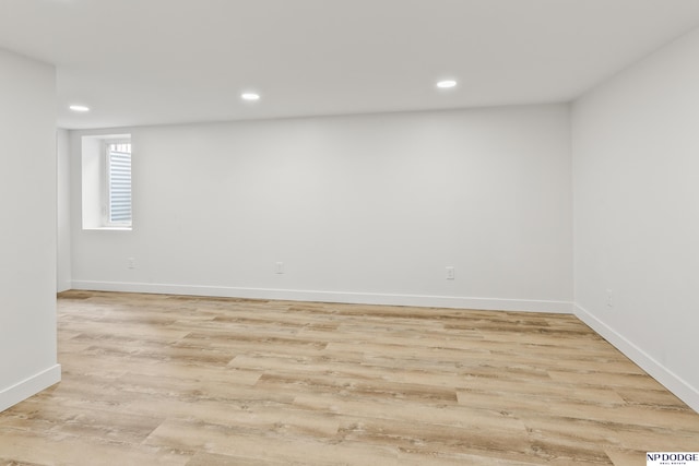 below grade area with recessed lighting, light wood-style floors, and baseboards