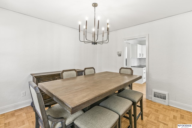 dining space with a chandelier and baseboards