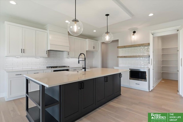 kitchen with open shelves, a sink, white cabinetry, and recessed lighting