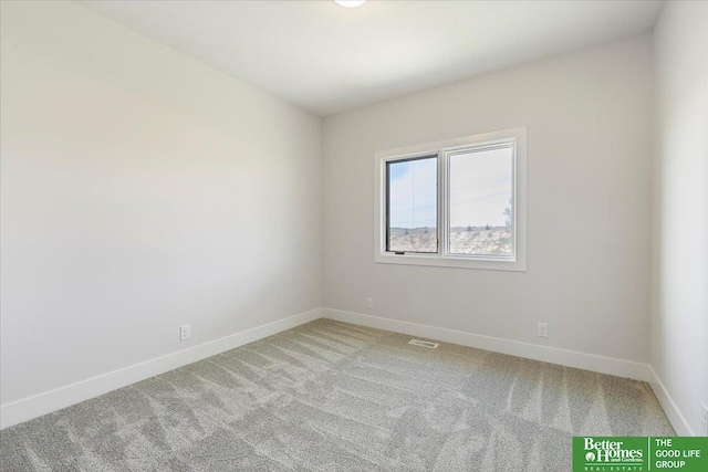 unfurnished room featuring light carpet and baseboards