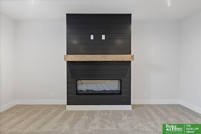 detailed view of a multi sided fireplace, carpet flooring, and baseboards
