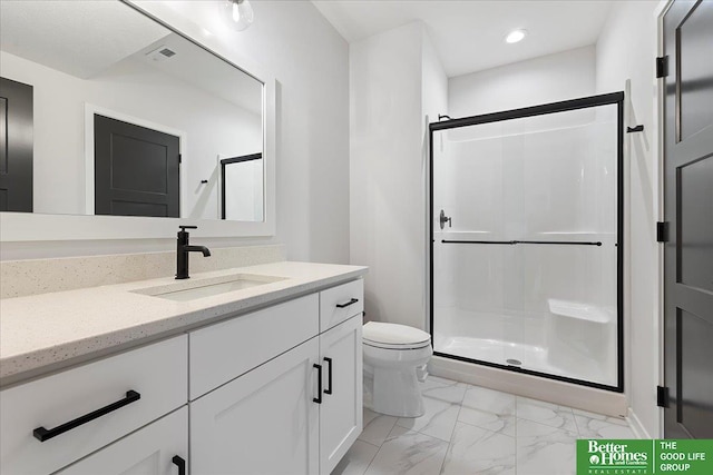 bathroom featuring a stall shower, marble finish floors, toilet, vanity, and recessed lighting