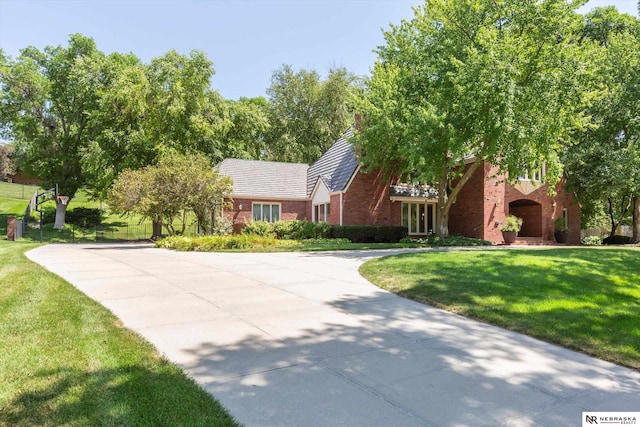 9723 Fieldcrest Dr, Omaha, NE 68114 - view of front of home featuring brick siding, a front lawn, and concrete driveway
