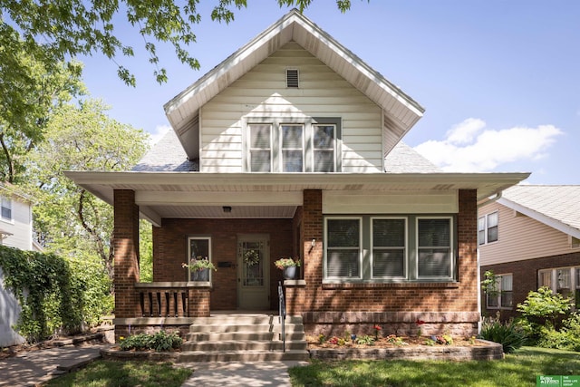 319 N 37th St, Omaha, NE 68131 - view of front facade featuring a porch, brick siding, and a shingled roof