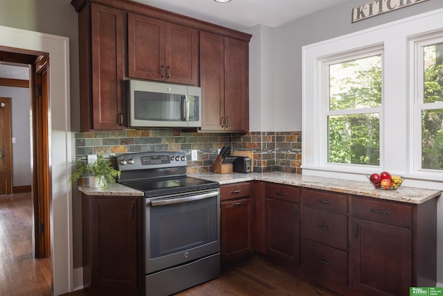 319 N 37th St, Omaha, NE 68131 - kitchen with appliances with stainless steel finishes, dark wood finished floors, healthy amount of natural light, and backsplash