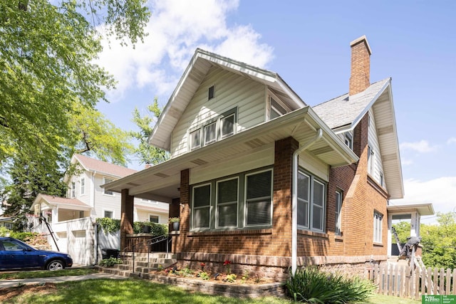 319 N 37th St, Omaha, NE 68131 - view of front of house with brick siding, a chimney, and a porch