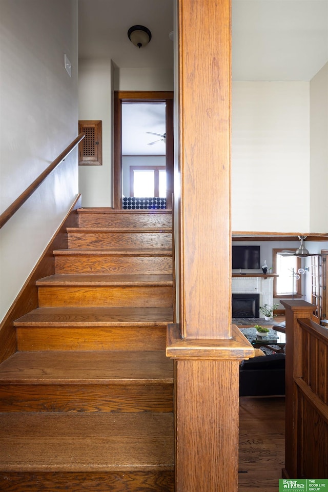 319 N 37th St, Omaha, NE 68131 - stairway featuring a fireplace and wood finished floors
