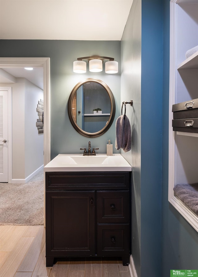 319 N 37th St, Omaha, NE 68131 - bathroom featuring vanity, wood finished floors, and baseboards