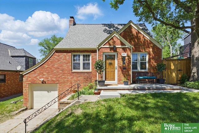 view of front facade featuring brick siding, a chimney, concrete driveway, a garage, and roof with shingles