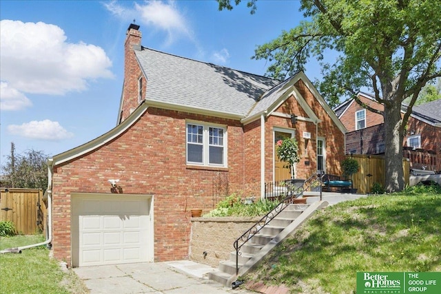 view of front of house with fence, brick siding, a chimney, roof with shingles, and driveway