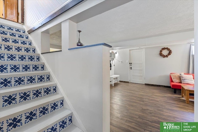 stairway with wood finished floors and baseboards