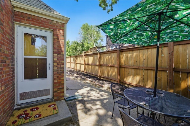 view of patio / terrace featuring fence and outdoor dining area