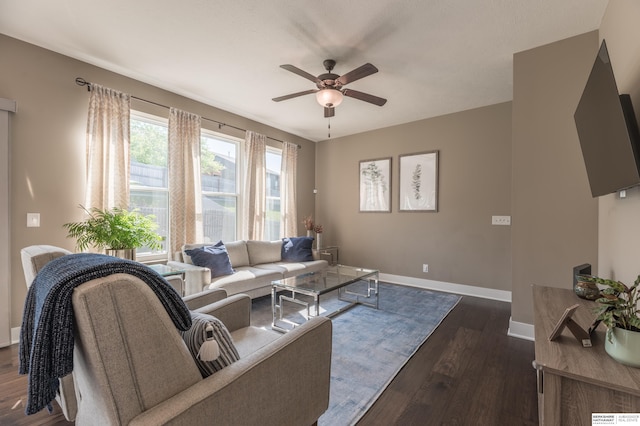 living room featuring a ceiling fan, dark wood finished floors, and baseboards