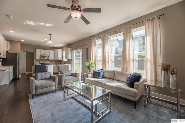 living room featuring healthy amount of natural light, dark wood finished floors, recessed lighting, a ceiling fan, and baseboards
