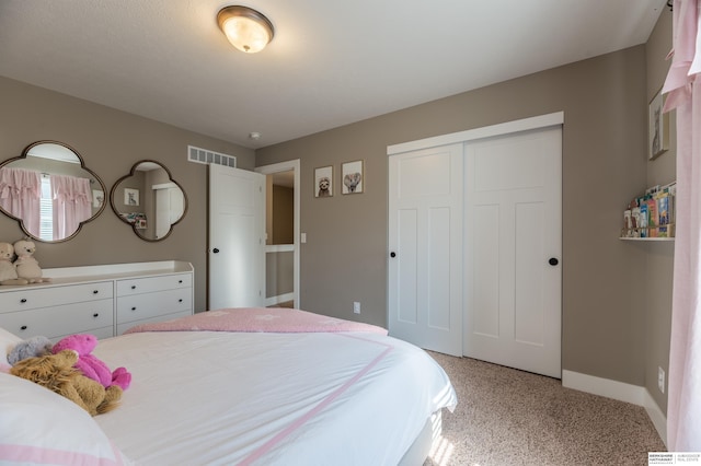 bedroom with baseboards, a closet, and light colored carpet