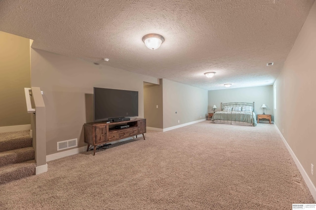 bedroom featuring carpet floors, a textured ceiling, and baseboards