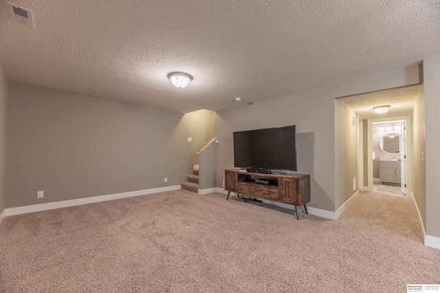 unfurnished living room featuring stairs, carpet, a textured ceiling, and baseboards