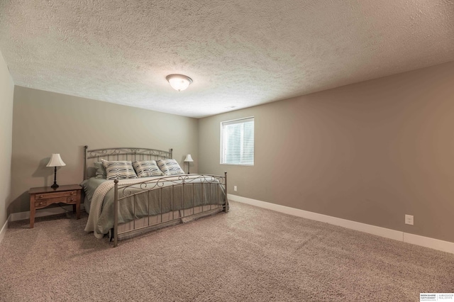 carpeted bedroom with baseboards and a textured ceiling