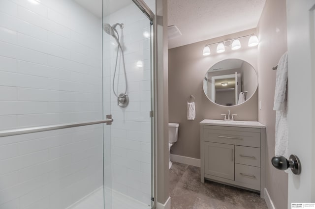 full bathroom with baseboards, a shower stall, vanity, toilet, and a textured ceiling